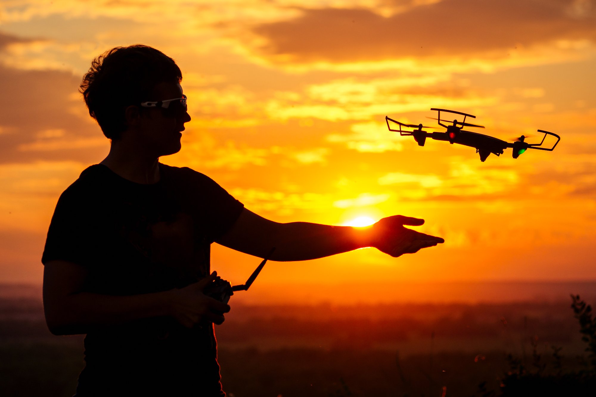 Drone pilot at sunset